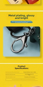 Close-up of polished dark green French Bulldog resin keychain with durable metal clasp