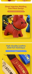 Close-up of resin French bulldog keychain with gold-stamped leather strap detailing