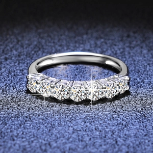 Classic S925 sterling silver seven-stone moissanite ring on a dark blue background
