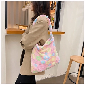 Side view of a soft plush floral tote bag shown on a model in a cafe setting