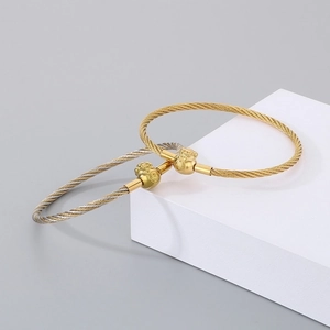 Detailed view of 3mm stainless steel twisted bangles with Pixiu luck beads and Fu character