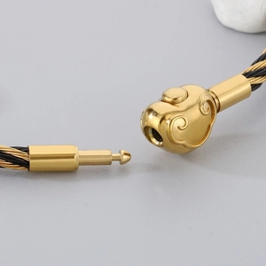 Macro shot of 3mm steel cord bracelet featuring lucky cloud buckle and gold plug clasp