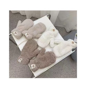 Detailed view of plush bear gloves in beige, white and dark brown soft wool fabric