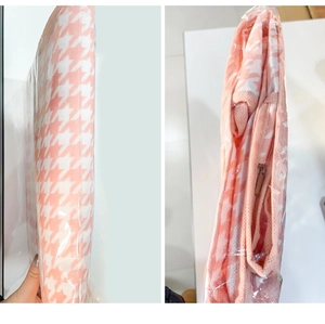 Detail view of pink houndstooth dust cover with metal zipper and foldable mesh fabric
