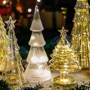 Lighted glass Christmas tree ornaments in frosted white, clear, and gold for festive decor