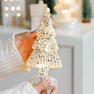Lighted glass Christmas tree with silver sequins and warm LED glow for holiday desk decor
