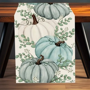 Autumn harvest table runner with white and light blue pumpkins on beige fabric