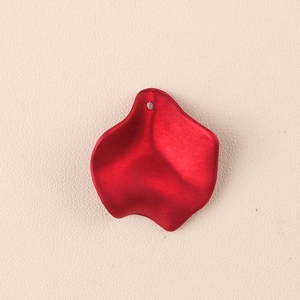 Close-up of bright red acrylic flower petal pendant with DIY hanging hole detail