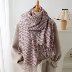 Pink and grey houndstooth cashmere feel scarf with fringes worn with a beige coat