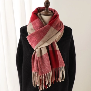 Classic red and beige plaid scarf with tassels made of warm soft knit fabric for winter