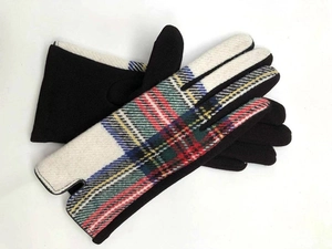 Detail of touchscreen gloves showing classic tartan pattern and conductive fingertip design