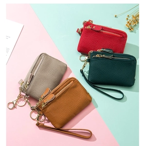 Flat lay of colorful pebble leather coin purses with wrist straps in four colors