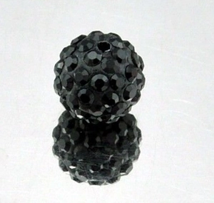 Macro shot of a black 8mm Shamballa disco clay bead with sparkling faceted rhinestones