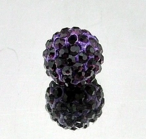 Macro shot of 8mm purple clay bead with faceted black rhinestones for jewelry making