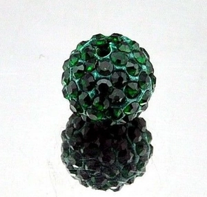 Macro shot of 10mm dark green Shamballa clay bead with full rhinestones and reflection