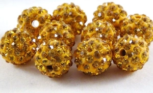 Macro view of a 10mm yellow Shamballa bead with faceted crystals for DIY jewelry