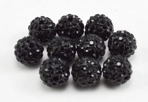 Macro shot of 8mm black clay disco ball beads with crystals for DIY jewelry making