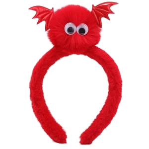Detail of red plush Halloween headband with bat wings and large white eyes decor