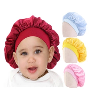 Detail of satin baby sleep bonnets in red, light blue, yellow and pink colors