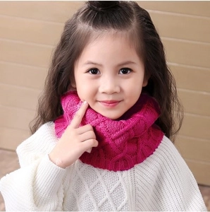 Kids knitted infinity scarf in rose red featuring a chunky cable knit pattern for winter