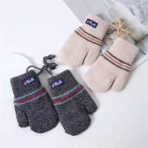 Macro detail of knit baby mittens in grey and beige with secure hanging strings