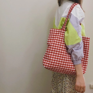 Classic red and white gingham canvas tote bag for women showing casual shoulder carry style