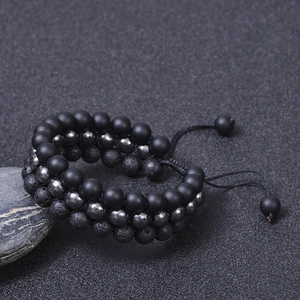 Three-layer men's natural volcanic stone and hematite beaded bracelet on a stone