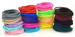 Detail view of 3mm colorful high-elastic seamless hair ties in a vibrant variety pack