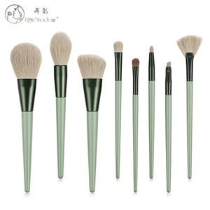 Detail view of 8 professional makeup brushes with Morandi green handles on white backdrop