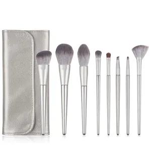 Detailed view of 8 professional makeup brushes with a silver pebble leather folding pouch