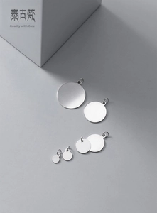 Macro view of six various sized matte S925 silver round disc pendants with jump rings
