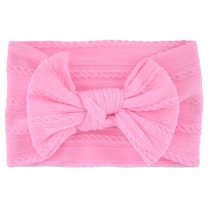 Close-up of pink cable knit baby headband with a large decorative soft bow detail