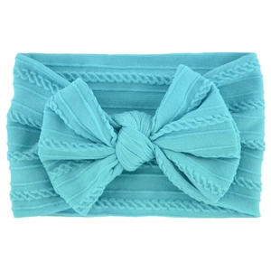 Detailed close-up of turquoise nylon baby headband with knitted texture and bow