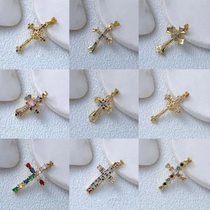 Detailed grid showing gold cross pendants with colorful cubic zirconia and gemstones