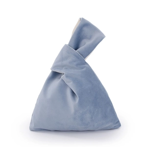 Detail of blue velvet Japanese knot bag showing the unique handle design and soft texture