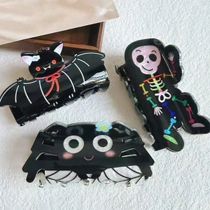 Halloween hair claws set with black spider, bat, and skull coffin designs for women