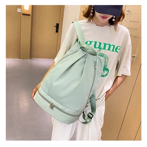 Detail showing the bottom independent shoe compartment on a mint green Oxford backpack