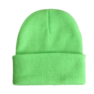 Close-up of the neon green knit beanie showing detailed texture and ribbed folded cuff