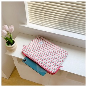 Detailed view of tulip floral laptop sleeve with smooth zipper and soft fabric texture
