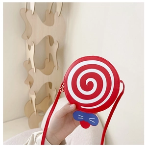 Detailed shot of red lollipop kids crossbody bag with white spiral and cute bow detail