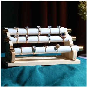 Three-tier velvet jewelry display stand with wooden base and elegant metal caps for rings