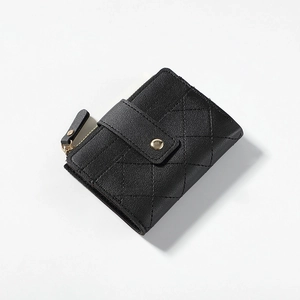 Detail of black quilted leather wallet with gold zipper and snap button closure
