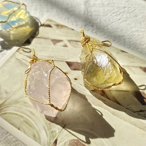 Three handmade wire-wrapped crystal pendants in pink and yellow 18K gold weaving