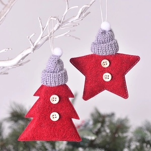 Red felt Christmas tree and star ornaments with grey knit hats hanging on white branches