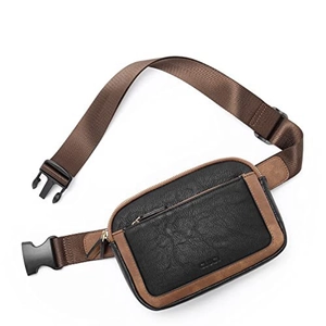 Detail view of black pebble-textured leather waist bag with brown trim and plastic buckle
