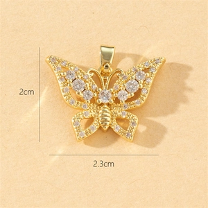 Macro shot of gold butterfly pendant with crystals showing 2cm by 2.3cm dimensions