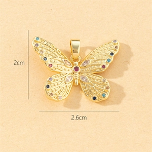 Detailed size view of a gold butterfly pendant with colored gems, 2cm x 2.6cm