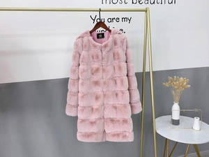 Detail view of the pink faux fur coat showing soft striped texture and round neckline