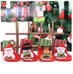 Detail of four festive Christmas stockings with Santa, Snowman, Reindeer, and Bear motifs