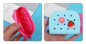 Macro shot of pink and blue silicone coin purses with cartoon flower and mushroom charms